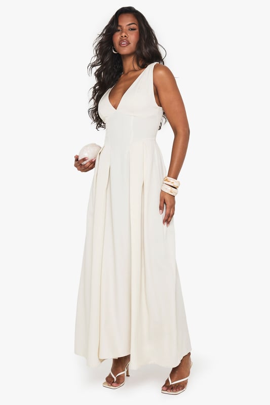 Textured crepe fabric with structured skater silhouette for added movement and flair
        Plunging V-neckline creates a striking focal point perfect for evening occasions
        Sleeveless design with elegant wide straps for comfortable support
        Maxi length with flowing skirt that gracefully skims the floor
        Pleated detailing at waist creates a flattering, feminine shape
    
    Make a statement at your next night out with this show-stopping skater maxidress from Boohoo. The textured crepe fabric adds subtle dimension while the plunging neckline creates a bold, confident look that demands attention. Style with strappy heels and statement bangles as seen on our model for a club-ready ensemble, or dress it up with metallic accessories and a sleek clutch for cocktails with friends. The flowing maxi silhouette moves beautifully as you dance, while the structured bodice provides a flattering fit that hugs in all the right places. This versatile piece transitions effortlessly from summer soires to autumn events with the addition of a cropped jacket. Perfect for those who want to combine comfort with head-turning style for urban nightlife adventures.