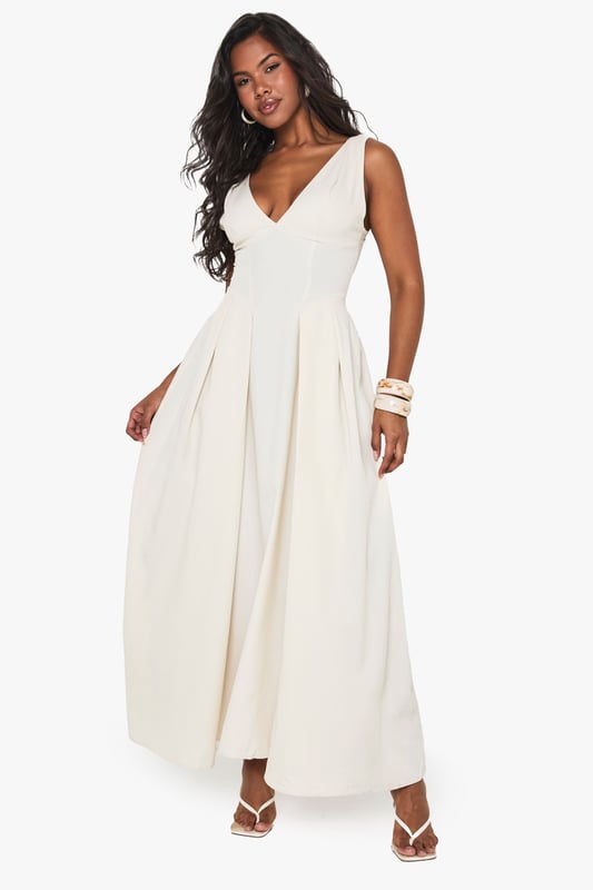 Textured crepe fabric with structured skater silhouette for added movement and flair
        Plunging V-neckline creates a striking focal point perfect for evening occasions
        Sleeveless design with elegant wide straps for comfortable support
        Maxi length with flowing skirt that gracefully skims the floor
        Pleated detailing at waist creates a flattering, feminine shape
    
    Make a statement at your next night out with this show-stopping skater maxidress from Boohoo. The textured crepe fabric adds subtle dimension while the plunging neckline creates a bold, confident look that demands attention. Style with strappy heels and statement bangles as seen on our model for a club-ready ensemble, or dress it up with metallic accessories and a sleek clutch for cocktails with friends. The flowing maxi silhouette moves beautifully as you dance, while the structured bodice provides a flattering fit that hugs in all the right places. This versatile piece transitions effortlessly from summer soires to autumn events with the addition of a cropped jacket. Perfect for those who want to combine comfort with head-turning style for urban nightlife adventures.