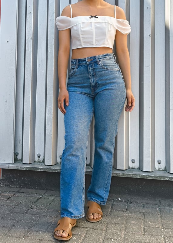 Elevate your casual style with our White Bow Detail Off Shoulder Top. This eye-catching piece features a flattering off-shoulder design with charming bow accents that add a touch of feminine flair. Perfect for summer days or evening outings, this versatile top pairs effortlessly with jeans, shorts, or skirts for a comfortable yet bold look that turns heads.