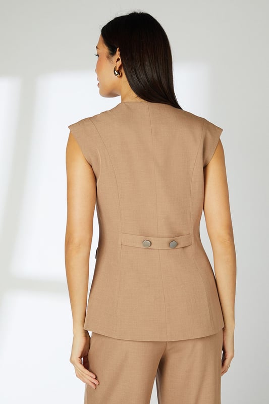 Sleek tailored waistcoat with distinctive cap sleeves for a contemporary silhouette
        Clean crew neckline complemented by statement button-through front closure
        Practical front pockets add functionality without compromising the streamlined design
        Subtle back detail with decorative buttons for added interest
        Regular fit offering comfortable movement whilst maintaining a polished appearance
    
    This versatile Principles waistcoat brings modern sophistication to your daywear collection. The clean lines and cap sleeve detail create a refined yet relaxed silhouette that works beautifully for various casual occasions. Style with the matching wide-leg trousers as shown for an effortlessly coordinated look, or pair with slim-fit denim and trainers for a smart-casual weekend ensemble. The structured woven fabric provides just enough stretch for all-day comfort, making it ideal for family gatherings or lunch with friends. Add simple gold-toned jewellery and a structured tote for a polished finish. This piece transitions seamlessly from day to evening - simply swap your flats for a block heel and add a bold lip colour for after-work drinks or dinner dates.