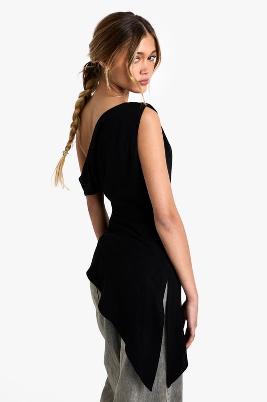 Striking one-shoulder design with elegant draping detail
        Asymmetric hemline creates a contemporary silhouette
        Soft linen-blend fabric offers comfort with a refined finish
        Versatile piece that transitions effortlessly from day to evening
        Flattering fit that accentuates the shoulder and dcolletage
    
    Make a statement with this beautifully draped one-shoulder top that combines contemporary design with effortless style. The asymmetric neckline and hemline create visual interest whilst the linen-blend fabric ensures comfort throughout the day. Style with relaxed trousers as seen on our model for a balanced silhouette that works perfectly for casual gatherings or weekend brunches. For evening occasions, pair with tailored trousers and statement earrings. Add a structured clutch and strappy heels to transform this versatile piece into an outfit worthy of dinner dates or gallery openings. The draped detail adds movement and dimension, making this top a standout addition to your wardrobe that can be styled in multiple ways across seasons.