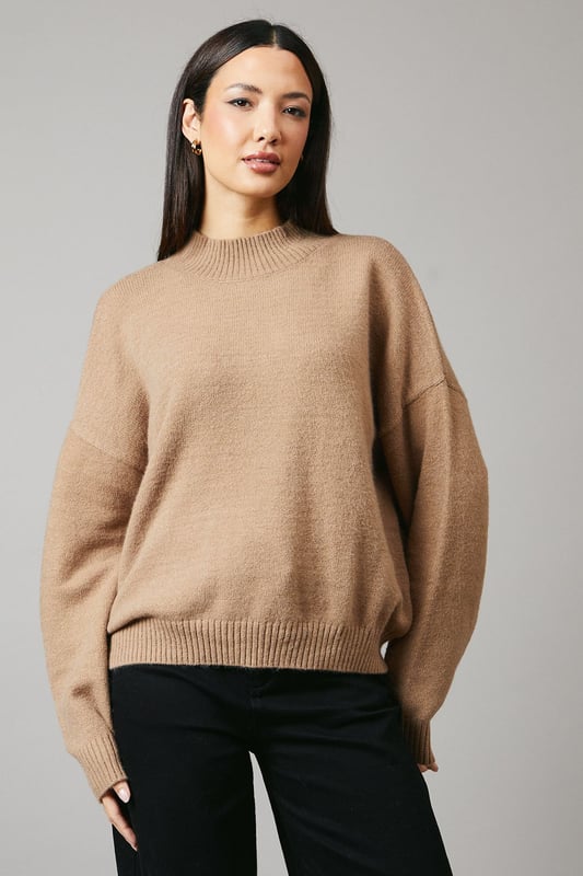Cosy high neck design for extra warmth
        Relaxed fit with dropped shoulders for effortless style
        Ribbed cuffs and hem for a snug finish
        Versatile knitted texture suitable for various occasions
        Cropped length perfect for high-waisted bottoms
    
    This Principles high neck jumper is a must-have addition to your autumn-winter wardrobe. The relaxed silhouette and dropped shoulders create a laid-back yet chic look, ideal for casual outings or cosy nights in. Style it with wide-leg trousers and ankle boots for a trendy daytime ensemble, or pair it with your favourite jeans and trainers for a quick coffee run. The cropped length makes it a perfect match for high-waisted bottoms, allowing you to experiment with proportions. For a touch of glamour, accessorise with statement earrings and a sleek clutch. This versatile jumper is your go-to piece for family gatherings, weekend brunches, or casual meetups with friends, offering both comfort and style in one effortless package.