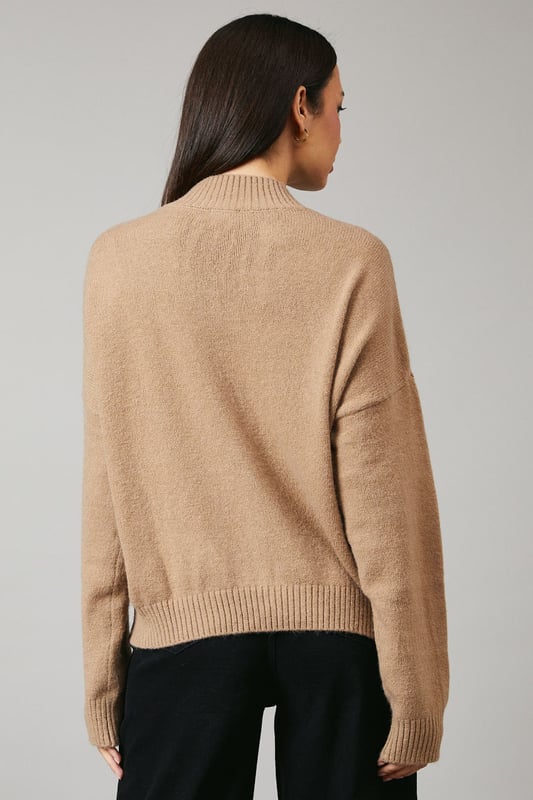 Cosy high neck design for extra warmth
        Relaxed fit with dropped shoulders for effortless style
        Ribbed cuffs and hem for a snug finish
        Versatile knitted texture suitable for various occasions
        Cropped length perfect for high-waisted bottoms
    
    This Principles high neck jumper is a must-have addition to your autumn-winter wardrobe. The relaxed silhouette and dropped shoulders create a laid-back yet chic look, ideal for casual outings or cosy nights in. Style it with wide-leg trousers and ankle boots for a trendy daytime ensemble, or pair it with your favourite jeans and trainers for a quick coffee run. The cropped length makes it a perfect match for high-waisted bottoms, allowing you to experiment with proportions. For a touch of glamour, accessorise with statement earrings and a sleek clutch. This versatile jumper is your go-to piece for family gatherings, weekend brunches, or casual meetups with friends, offering both comfort and style in one effortless package.