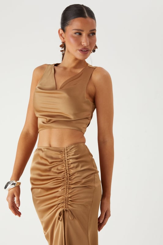 Luxurious satin co-ord featuring a flattering cowl neckline top and statement maxi skirt
        Elegant ruched detailing along the skirt front creates a figure-enhancing silhouette
        Daring side split in the maxi skirt adds movement and reveals just the right amount of leg
        Stylish tie-back detail on the top for an adjustable and secure fit
        Sleek crop top design pairs perfectly with the high-waisted maxi skirt for a contemporary two-piece look
    
    Make a striking entrance at your next special occasion in this showstopping satin co-ord from MissPap. The combination of the cowl neck crop top and ruched maxi skirt creates a contemporary silhouette that commands attention. Style with strappy heels and statement earrings as seen on our model for maximum impact at formal events. The high-waisted design of the skirt elongates your figure, whilst the side split adds a touch of drama to your movement. Perfect for weddings, graduation ceremonies or evening galas, this versatile co-ord can be dressed up with metallic accessories for a glamorous finish. For cooler evenings, layer with a tailored blazer without compromising on style. The satin fabric catches the light beautifully as you move, ensuring all eyes are on you throughout the night.
