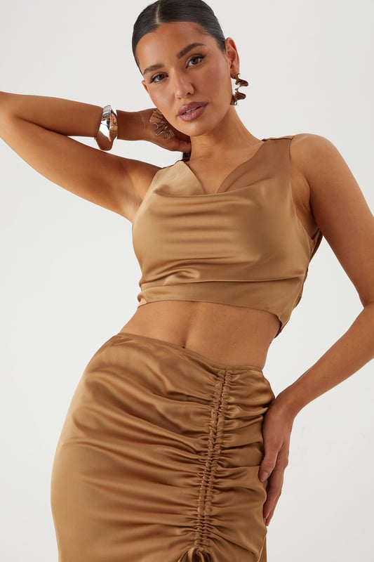 Luxurious satin co-ord featuring a flattering cowl neckline top and statement maxi skirt
        Elegant ruched detailing along the skirt front creates a figure-enhancing silhouette
        Daring side split in the maxi skirt adds movement and reveals just the right amount of leg
        Stylish tie-back detail on the top for an adjustable and secure fit
        Sleek crop top design pairs perfectly with the high-waisted maxi skirt for a contemporary two-piece look
    
    Make a striking entrance at your next special occasion in this showstopping satin co-ord from MissPap. The combination of the cowl neck crop top and ruched maxi skirt creates a contemporary silhouette that commands attention. Style with strappy heels and statement earrings as seen on our model for maximum impact at formal events. The high-waisted design of the skirt elongates your figure, whilst the side split adds a touch of drama to your movement. Perfect for weddings, graduation ceremonies or evening galas, this versatile co-ord can be dressed up with metallic accessories for a glamorous finish. For cooler evenings, layer with a tailored blazer without compromising on style. The satin fabric catches the light beautifully as you move, ensuring all eyes are on you throughout the night.