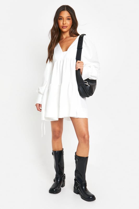 Tiered smock design for a flattering silhouette
        Voluminous puff sleeves add a romantic touch
        V-neckline enhances the feminine appeal
        Relaxed fit for ultimate comfort and ease of movement
        Versatile length suitable for various casual occasions
    
    Embrace effortless style with this charming tiered smock dress from Boohoo. Perfect for the fashion-forward woman who values both comfort and trend-setting looks, this dress radiates a carefree vibe ideal for various casual settings. The tiered design creates a flattering silhouette that skims the body, while the puff sleeves add a touch of whimsy and romance. Style it with chunky boots for an edgy contrast, or pair with your favourite trainers for a laid-back ensemble. Whether you're heading to a family gathering, brunch with friends, or a casual day out, this dress offers the versatility you need. Accessorise with a crossbody bag and delicate jewellery to complete your look. Easy to wear and effortlessly chic, this dress is a must-have addition to your wardrobe, embodying Boohoo's commitment to accessible, on-trend fashion for the young, social butterfly.