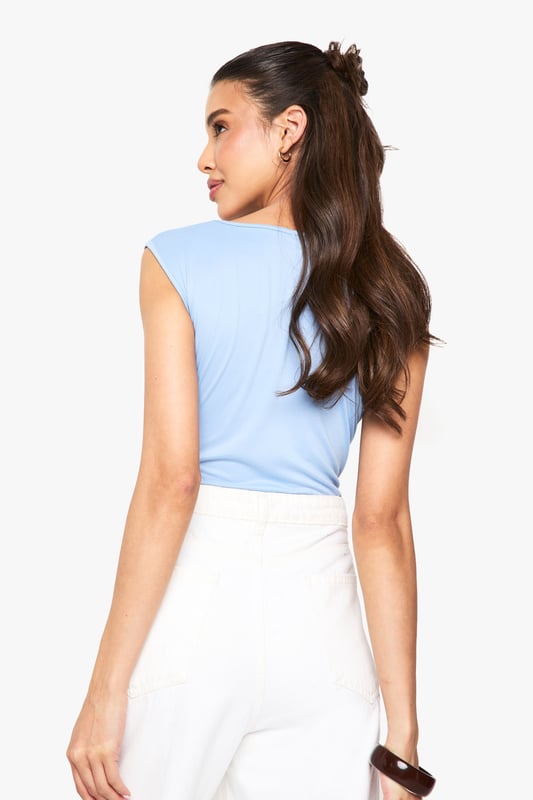 Soft touch bodysuit with elegant ruched bust detail
        Flattering sweetheart neckline for a feminine silhouette
        Sleeveless design perfect for layering or wearing alone
        Figure-hugging fit with stretch for all-day comfort
        Versatile piece that transitions effortlessly from day to night
    
    This ultra-soft bodysuit combines comfort with chic styling, making it a wardrobe essential for the fashion-forward woman. The ruched bust detail and sweetheart neckline create a flattering shape that complements all figures. Style with high-waisted white trousers and a slim belt for a polished daytime look, as shown on our model. For evening occasions, swap the casual accessories for statement jewellery and a structured blazer. The sleek design tucks in perfectly without bunching, creating a seamless silhouette that works brilliantly under both tailored and relaxed pieces. Perfect for casual gatherings or dressed up for drinks with the girls, this bodysuit offers endless styling possibilities throughout the seasons.