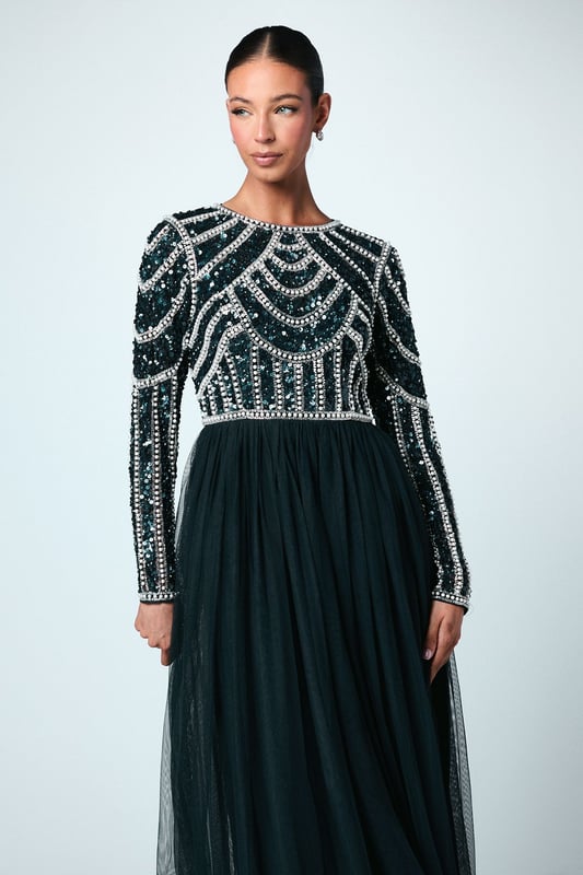 If a showstopping bridesmaid gown is what you're looking for, you're in the right place. Featuring a bodice swathed in dazzling sequins that glimmer in an art-deco pattern under the light, this design is finished by a delicate tulle skirt, adding to the sophisticated, old-time glamour aesthetic. Made from embellished sequins: exquisitely ornated with hand-sewn beads, this luxurious fabrication has a heavyweight feel, encasing your figure for a sculptural silhouette. Every unique pattern is created exclusively in-house by a team of artists. Level of stretch: none. This dress fastens with a rear concealed zip.This style is part of the Coast Honoured Collection, a dedicated range of never out-of-stock, bridesmaid dresses guaranteed to favour every member of your bridal party. Available in a selection of bestselling colour palettes, perfect for mix-and-match groups.