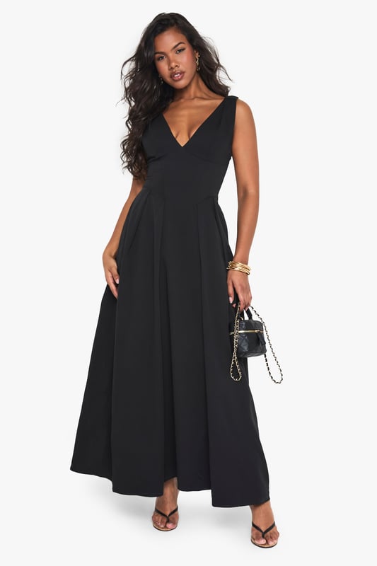 Textured crepe fabric adds subtle dimension and visual interest to this skater-style maxi dress
        Flattering plunge neckline creates an elegant focal point for evening occasions
        Sleeveless design offers comfort for dancing the night away
        Full skater skirt with structured pleating creates a dramatic silhouette
        Floor-length maxi cut makes a bold statement for special nights out
    
    Make an entrance in this striking skater maxi dress from Boohoo. The textured crepe fabric drapes beautifully whilst maintaining structure, creating a flattering silhouette that moves gracefully as you walk. The plunge neckline adds a touch of allure without overwhelming, perfect for evening cocktails or club nights. Style with strappy heels and statement jewellery as seen on our model for maximum impact, or dress down with a cropped jacket and chunky heels for drinks with friends. The versatile design transitions effortlessly from bar to dancefloor, making it an essential addition to your going-out wardrobe. For cooler evenings, layer with a fitted blazer and clutch bag to maintain the dress's elegant lines whilst adding practicality.