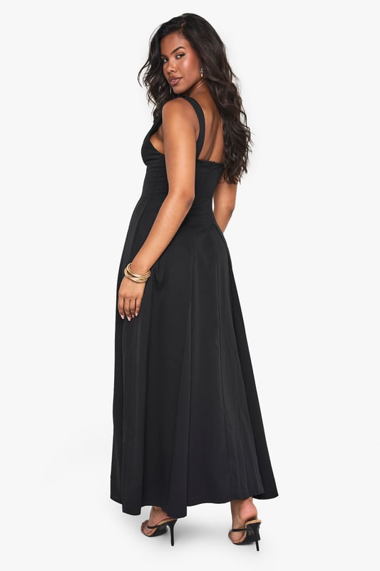 Textured crepe fabric adds subtle dimension and visual interest to this skater-style maxi dress
        Flattering plunge neckline creates an elegant focal point for evening occasions
        Sleeveless design offers comfort for dancing the night away
        Full skater skirt with structured pleating creates a dramatic silhouette
        Floor-length maxi cut makes a bold statement for special nights out
    
    Make an entrance in this striking skater maxi dress from Boohoo. The textured crepe fabric drapes beautifully whilst maintaining structure, creating a flattering silhouette that moves gracefully as you walk. The plunge neckline adds a touch of allure without overwhelming, perfect for evening cocktails or club nights. Style with strappy heels and statement jewellery as seen on our model for maximum impact, or dress down with a cropped jacket and chunky heels for drinks with friends. The versatile design transitions effortlessly from bar to dancefloor, making it an essential addition to your going-out wardrobe. For cooler evenings, layer with a fitted blazer and clutch bag to maintain the dress's elegant lines whilst adding practicality.