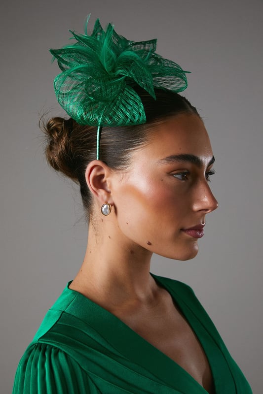 Exquisite open weave design with delicate bow and feather detailing
Lightweight and airy fascinator crafted from fancy fabric
Headpiece features a slender, curved headband for a secure fit
Intricate weave pattern creates a captivating textural effect
Versatile accessory to elevate your ensemble for formal occasions

Radiate sophistication and elegance with this stunning fascinator from Coast. The open weave design, adorned with a delicate bow and feather embellishments, exudes a refined and feminine aesthetic. Crafted from a lightweight and airy fancy fabric, this headpiece is the perfect accompaniment to your formal attire, whether you're attending a wedding, the races, or a graduation ceremony. Its slender, curved headband ensures a secure and comfortable fit, allowing you to confidently embrace the occasion. Style this versatile fascinator with a tailored dress or a chic jumpsuit for a polished and sophisticated look that commands attention.