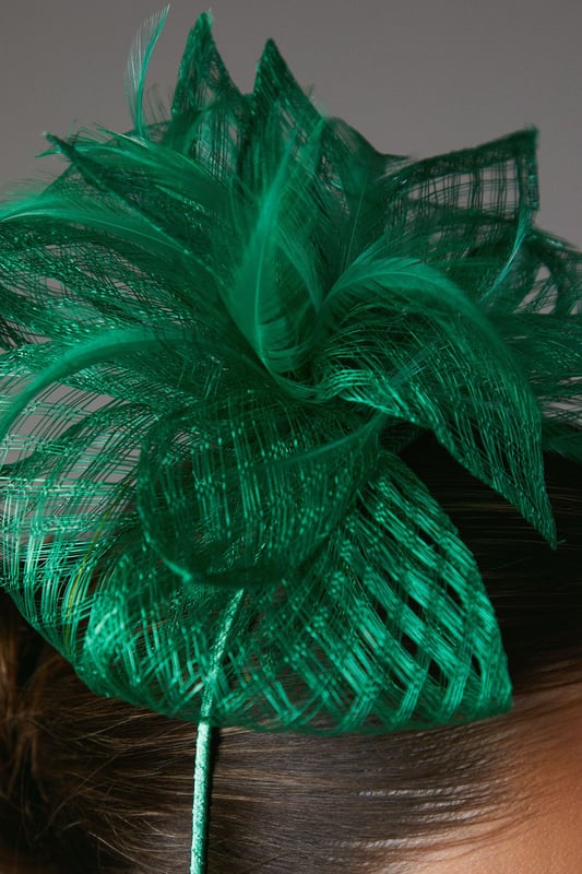 Exquisite open weave design with delicate bow and feather detailing
Lightweight and airy fascinator crafted from fancy fabric
Headpiece features a slender, curved headband for a secure fit
Intricate weave pattern creates a captivating textural effect
Versatile accessory to elevate your ensemble for formal occasions

Radiate sophistication and elegance with this stunning fascinator from Coast. The open weave design, adorned with a delicate bow and feather embellishments, exudes a refined and feminine aesthetic. Crafted from a lightweight and airy fancy fabric, this headpiece is the perfect accompaniment to your formal attire, whether you're attending a wedding, the races, or a graduation ceremony. Its slender, curved headband ensures a secure and comfortable fit, allowing you to confidently embrace the occasion. Style this versatile fascinator with a tailored dress or a chic jumpsuit for a polished and sophisticated look that commands attention.