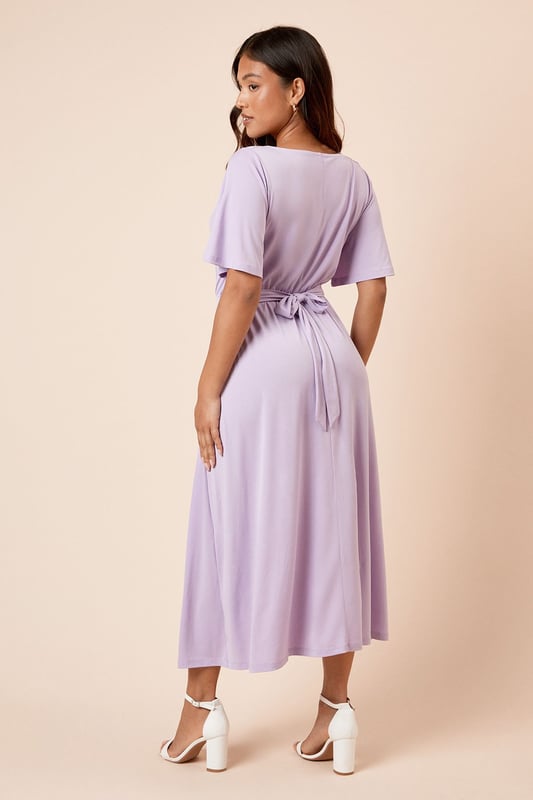 Elegant cowl neckline creates a soft, draped effect at the front
        Flutter sleeves add a feminine touch and gentle movement
        Flattering midi length falls elegantly below the knee
        Tie-back detail creates a customised fit and adds visual interest
        Defined waistline creates a figure-enhancing silhouette
    
    This Dorothy Perkins midi dress combines comfort with sophistication through its graceful cowl neckline and flowing silhouette. The delicate flutter sleeves provide just the right amount of coverage whilst maintaining a light, airy feel. The tie-back detail allows for a personalised fit that accentuates your waistline beautifully. Style with simple strappy sandals and minimal jewellery for casual brunches with the girls, or dress it up with block-heeled ankle boots and a structured crossbody bag for family gatherings. The versatile design makes it perfect for baby showers or afternoon tea, where you can pair it with a lightweight cardigan and ballet flats for a polished yet comfortable ensemble. This dress transitions effortlessly from daytime casual to evening drinks with a simple change of accessories.
