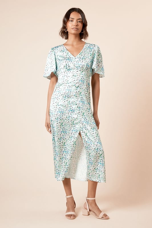 Elegant V-neckline complemented by feminine angel sleeves for a soft, fluttery silhouette
        Midi length design offering sophisticated coverage whilst maintaining a contemporary feel
        Delicate all-over print that adds visual interest to this versatile piece
        Flattering cinched waist detail that creates a beautifully defined silhouette
        Lightweight woven fabric ensuring comfort and ease of movement throughout the day
    
    This charming midi dress from Dorothy Perkins strikes the perfect balance between casual comfort and refined style. The graceful angel sleeves create a soft, feminine frame whilst the V-neckline adds a touch of subtle allure. The cinched waist design gently defines your silhouette, flowing into an elegant midi length that's both practical and stylish. Perfect for casual gatherings, this dress pairs beautifully with flat sandals and a woven tote for weekend brunches with friends. For baby showers or family celebrations, style with block-heeled sandals and delicate jewellery for a polished finish. The versatile design transitions effortlessly from daytime casual to evening drinks - simply swap your flats for ankle boots and add a cropped denim jacket as temperatures cool. Machine washable for easy care, this dress promises to become a cherished staple in your wardrobe.