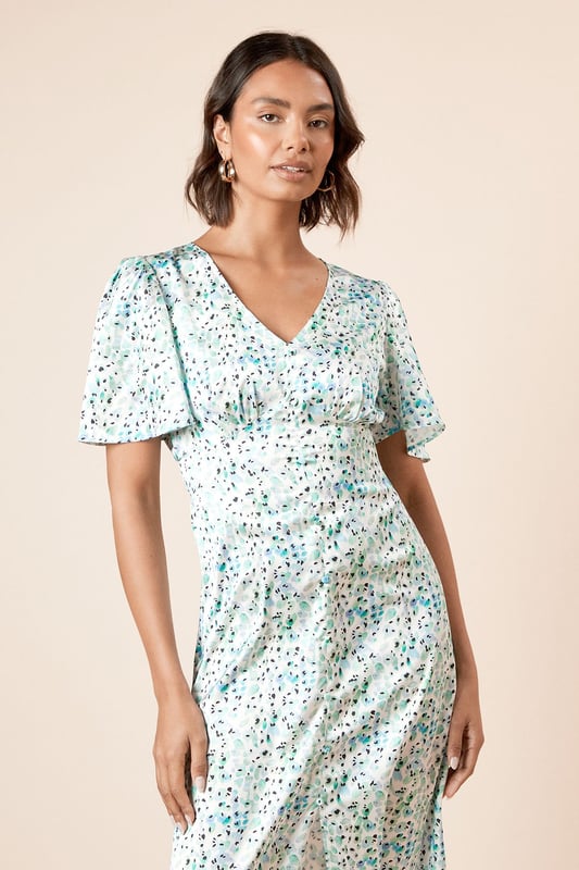 Elegant V-neckline complemented by feminine angel sleeves for a soft, fluttery silhouette
        Midi length design offering sophisticated coverage whilst maintaining a contemporary feel
        Delicate all-over print that adds visual interest to this versatile piece
        Flattering cinched waist detail that creates a beautifully defined silhouette
        Lightweight woven fabric ensuring comfort and ease of movement throughout the day
    
    This charming midi dress from Dorothy Perkins strikes the perfect balance between casual comfort and refined style. The graceful angel sleeves create a soft, feminine frame whilst the V-neckline adds a touch of subtle allure. The cinched waist design gently defines your silhouette, flowing into an elegant midi length that's both practical and stylish. Perfect for casual gatherings, this dress pairs beautifully with flat sandals and a woven tote for weekend brunches with friends. For baby showers or family celebrations, style with block-heeled sandals and delicate jewellery for a polished finish. The versatile design transitions effortlessly from daytime casual to evening drinks - simply swap your flats for ankle boots and add a cropped denim jacket as temperatures cool. Machine washable for easy care, this dress promises to become a cherished staple in your wardrobe.