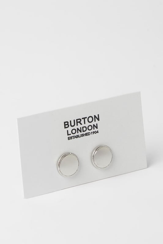 Circular design with textured silver detailing around the edge
        Smooth central face for a refined finish
        Secure T-bar fastening for easy application
        Classic metallic finish that complements any formal shirt
        Subtle yet distinctive accessory to complete your smart ensemble
    
    These sophisticated circle cufflinks add a touch of distinction to any formal outfit. The elegant silver detailing creates a subtle texture that catches the light without being overstated. Perfect for completing your suit for important meetings, weddings or evening events where attention to detail matters. Pair with a crisp white or light blue shirt to showcase the metallic finish, or match with a darker shirt for a striking contrast. These versatile accessories work brilliantly with both French cuff and double cuff shirts, allowing you to customise your look for various occasions. A staple for the modern gentleman who appreciates classic styling with contemporary appeal - these cufflinks strike the perfect balance between traditional formality and understated style that Burton is known for.