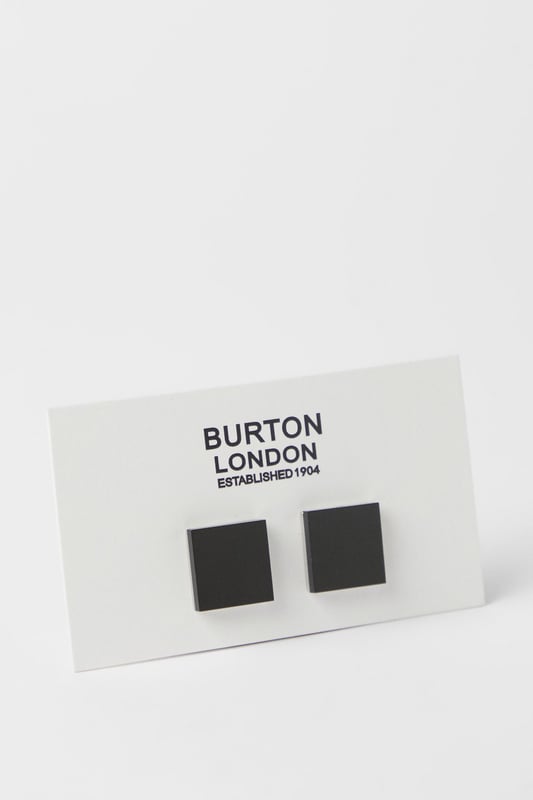 Classic square design with contrasting black face and polished silver trim
        Secure T-bar fastening for reliable wear throughout formal occasions
        Versatile size that complements both standard and French cuffs
        Sleek metal construction offering durability and a refined finish
        Burton London signature quality, perfect for adding subtle sophistication to any formal ensemble
    
    These timeless black and silver cufflinks present the perfect finishing touch for your formal attire. The understated square design offers versatility that complements a range of shirt styles and suit colours, making them an essential addition to your accessories collection. Pair with a crisp white shirt and tailored Burton suit for important business meetings or special occasions where attention to detail matters. The contrasting elements create visual interest without overwhelming your overall look - ideal for the gentleman who appreciates classic style with contemporary appeal. These cufflinks transition effortlessly from daytime professional settings to evening functions, ensuring you're always appropriately dressed for the occasion. A smart investment piece that will serve your wardrobe for years to come, reflecting a considered approach to formal dressing that never goes out of fashion.