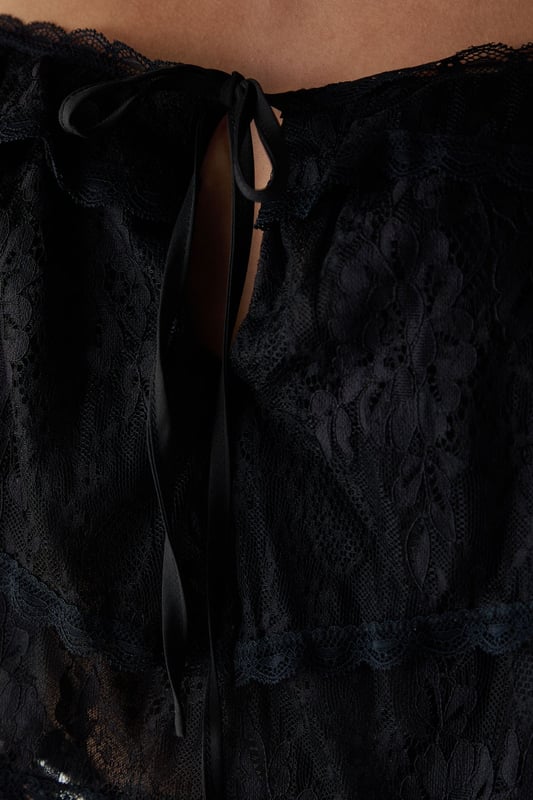 Delicate lace overlay with intricate bohemian-inspired pattern
        Adjustable tie straps for a customised fit
        Cropped length perfect for high-waisted styling
        Tiered design creating a relaxed, floaty silhouette
        Subtle front tie detail adding feminine charm
    
    This Warehouse Bohemian Lace Cami Top brings effortless style to your casual wardrobe. The delicate lace construction creates a light, airy feel while the cropped silhouette pairs beautifully with high-waisted bottoms. Style with light-wash denim shorts and western boots for a festival-ready look, or team with wide-leg trousers and trainers for weekend brunches. The adjustable straps ensure comfort throughout the day, while the tiered design adds movement and dimension. Perfect for summer gatherings, garden parties or holiday evenings, this versatile piece can be dressed down with a denim jacket or styled with statement jewellery for more special occasions. Machine washable for easy care, this top combines practicality with Warehouse's signature confident, feminine aesthetic.