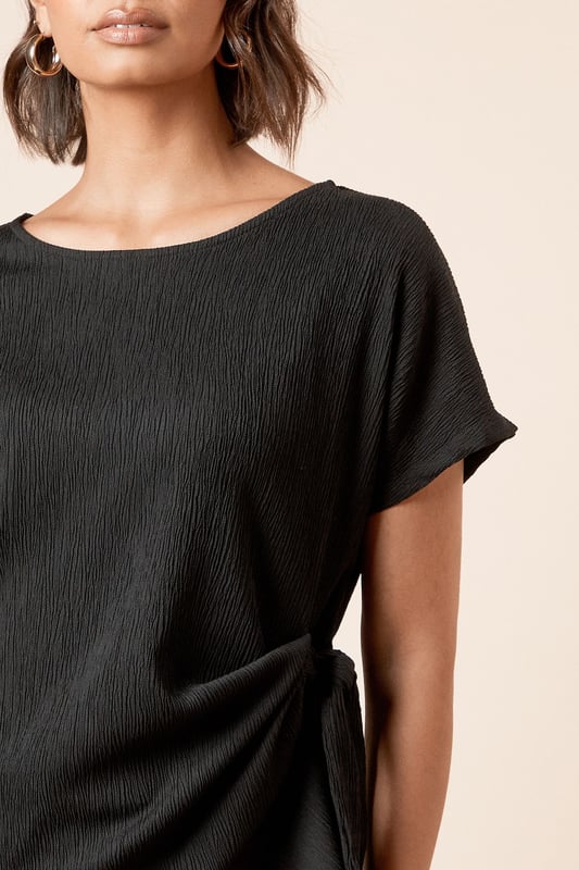 Elegant jersey t-shirt featuring a distinctive side knot detail that creates a flattering silhouette
        Classic crew neckline offers versatile styling options for both daytime and evening looks
        Short sleeves with a relaxed fit provide comfortable movement throughout the day
        Soft, textured jersey fabric with slight stretch ensures all-day comfort and shape retention
        Side tie detail adds a contemporary twist to this wardrobe essential
    
    This Dorothy Perkins knot tie side t-shirt effortlessly blends comfort with sophistication. The thoughtful side tie detail creates gentle gathering that flatters your figure whilst adding visual interest to an otherwise simple silhouette. Perfect for casual brunches with friends, pair with wide-leg trousers and sandals as shown for an effortlessly chic daytime ensemble. For family gatherings, style with your favourite denim and ballet flats for a polished yet relaxed look. The versatile crew neckline works beautifully with delicate jewellery for those occasions when you want to appear put-together without trying too hard. The textured jersey fabric drapes beautifully and maintains its shape throughout the day, making this top a reliable choice for your busy lifestyle. A true wardrobe staple that transitions seamlessly from casual coffee dates to baby showers with just a change of accessories.