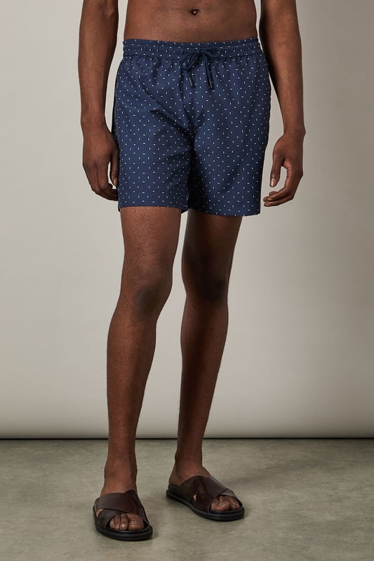 Stylish dash print design for a contemporary poolside look
        Quick-drying woven fabric for comfort in and out of the water
        Adjustable drawstring waist for a secure, customisable fit
        Mid-thigh length offering balanced coverage and freedom of movement
        Mesh lining for added comfort and support whilst swimming
    
    These Burton swim shorts combine practicality with classic style, perfect for the man who appreciates timeless design. The dash print adds subtle visual interest without being overly trendy, making these shorts a versatile addition to your holiday wardrobe. Style them as seen with a crisp white shirt for beachside lunches or evening drinks at the resort bar. For casual pool days, pair simply with your favourite sunglasses and sandals. The comfortable fit and practical design make these shorts ideal for everything from swimming laps to relaxing with a cold drink at a family barbecue. They'll take you effortlessly from the beach to a casual pub lunch with mates, offering the versatility that modern life demands without compromising on Burton's trusted quality and classic appeal.