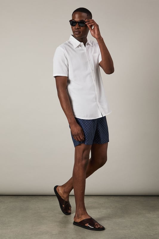 Stylish dash print design for a contemporary poolside look
        Quick-drying woven fabric for comfort in and out of the water
        Adjustable drawstring waist for a secure, customisable fit
        Mid-thigh length offering balanced coverage and freedom of movement
        Mesh lining for added comfort and support whilst swimming
    
    These Burton swim shorts combine practicality with classic style, perfect for the man who appreciates timeless design. The dash print adds subtle visual interest without being overly trendy, making these shorts a versatile addition to your holiday wardrobe. Style them as seen with a crisp white shirt for beachside lunches or evening drinks at the resort bar. For casual pool days, pair simply with your favourite sunglasses and sandals. The comfortable fit and practical design make these shorts ideal for everything from swimming laps to relaxing with a cold drink at a family barbecue. They'll take you effortlessly from the beach to a casual pub lunch with mates, offering the versatility that modern life demands without compromising on Burton's trusted quality and classic appeal.