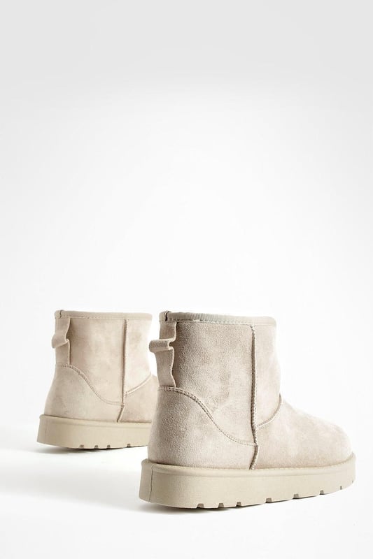 Cosy ankle-height boots for ultimate comfort
        Soft synthetic suede upper for a luxurious feel
        Chunky, durable sole for enhanced grip and stability
        Pull-tab at the back for easy on-and-off
        Versatile design suitable for various casual outfits
    
    Step into comfort and style with these Mini Cosy Boots from Boohoo. Perfect for the fashion-forward woman who values both trendy looks and practicality, these boots are a must-have addition to your casual wardrobe. The ankle-height design offers versatility, making them ideal for pairing with everything from skinny jeans to floaty dresses. The chunky sole not only provides excellent traction but also adds a contemporary edge to your ensemble. Whether you're heading to a laid-back brunch with friends or embarking on a weekend shopping spree, these boots will keep you looking chic and feeling comfortable all day long. For a effortlessly cool look, try teaming them with leggings and an oversized jumper, or dress them up with a midi skirt and cropped jacket for those cooler evenings out.