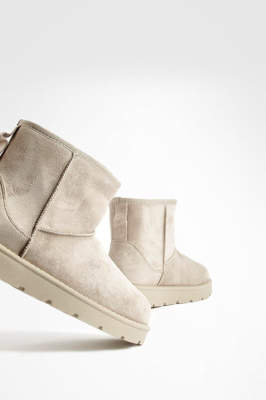 Cosy ankle-height boots for ultimate comfort
        Soft synthetic suede upper for a luxurious feel
        Chunky, durable sole for enhanced grip and stability
        Pull-tab at the back for easy on-and-off
        Versatile design suitable for various casual outfits
    
    Step into comfort and style with these Mini Cosy Boots from Boohoo. Perfect for the fashion-forward woman who values both trendy looks and practicality, these boots are a must-have addition to your casual wardrobe. The ankle-height design offers versatility, making them ideal for pairing with everything from skinny jeans to floaty dresses. The chunky sole not only provides excellent traction but also adds a contemporary edge to your ensemble. Whether you're heading to a laid-back brunch with friends or embarking on a weekend shopping spree, these boots will keep you looking chic and feeling comfortable all day long. For a effortlessly cool look, try teaming them with leggings and an oversized jumper, or dress them up with a midi skirt and cropped jacket for those cooler evenings out.
