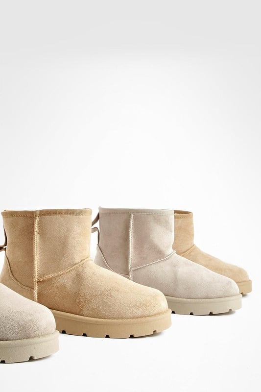 Cosy ankle-height boots for ultimate comfort
        Soft synthetic suede upper for a luxurious feel
        Chunky, durable sole for enhanced grip and stability
        Pull-tab at the back for easy on-and-off
        Versatile design suitable for various casual outfits
    
    Step into comfort and style with these Mini Cosy Boots from Boohoo. Perfect for the fashion-forward woman who values both trendy looks and practicality, these boots are a must-have addition to your casual wardrobe. The ankle-height design offers versatility, making them ideal for pairing with everything from skinny jeans to floaty dresses. The chunky sole not only provides excellent traction but also adds a contemporary edge to your ensemble. Whether you're heading to a laid-back brunch with friends or embarking on a weekend shopping spree, these boots will keep you looking chic and feeling comfortable all day long. For a effortlessly cool look, try teaming them with leggings and an oversized jumper, or dress them up with a midi skirt and cropped jacket for those cooler evenings out.