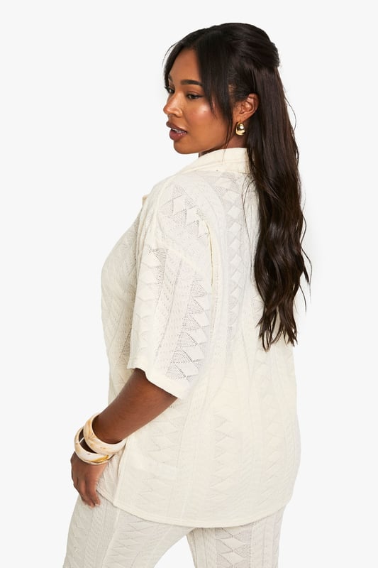 Textured fabric with distinctive geometric pattern throughout
        Relaxed fit with short sleeves for effortless beach style
        Classic collar design with full button-through front
        Versatile shirt silhouette that pairs perfectly with matching trousers
        Plus size design crafted specifically for curvy figures
    
    This structured Mix & Match shirt from Boohoo is your essential beach holiday companion. The textured fabric creates visual interest while the relaxed silhouette ensures comfort during warm-weather escapes. Style as seen with the coordinating wide-leg trousers for a sophisticated beach-to-bar ensemble, or wear unbuttoned over your favourite swimwear as a chic cover-up. The neutral tone makes it incredibly versatile for holiday packing, while the short sleeves offer just the right amount of coverage for sunny afternoons. Perfect for lounging by the pool with a cocktail, strolling along the promenade, or enjoying sunset dinners at beachfront restaurants. Accessorise with layered necklaces and statement bangles as shown for a complete resort-ready look that transitions seamlessly from daytime relaxation to evening socialising.