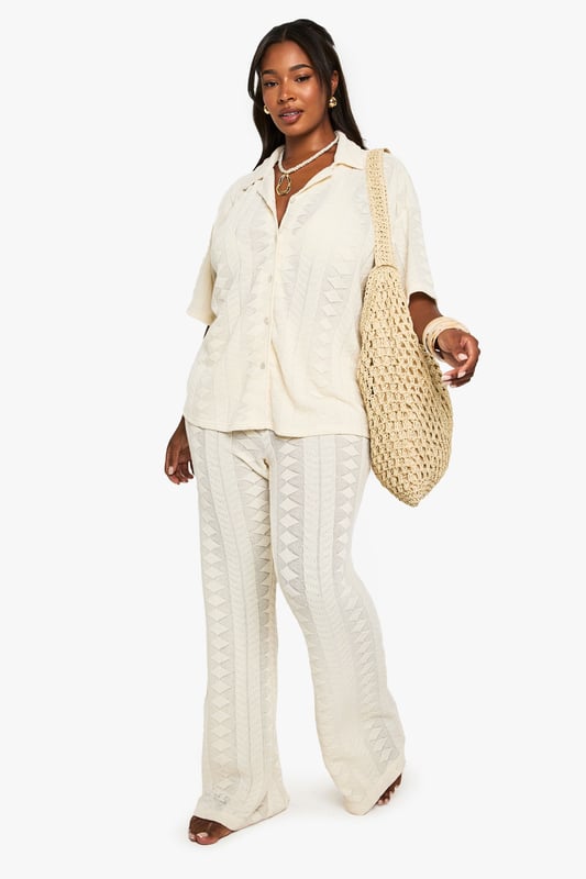 Textured fabric with distinctive geometric pattern throughout
        Relaxed fit with short sleeves for effortless beach style
        Classic collar design with full button-through front
        Versatile shirt silhouette that pairs perfectly with matching trousers
        Plus size design crafted specifically for curvy figures
    
    This structured Mix & Match shirt from Boohoo is your essential beach holiday companion. The textured fabric creates visual interest while the relaxed silhouette ensures comfort during warm-weather escapes. Style as seen with the coordinating wide-leg trousers for a sophisticated beach-to-bar ensemble, or wear unbuttoned over your favourite swimwear as a chic cover-up. The neutral tone makes it incredibly versatile for holiday packing, while the short sleeves offer just the right amount of coverage for sunny afternoons. Perfect for lounging by the pool with a cocktail, strolling along the promenade, or enjoying sunset dinners at beachfront restaurants. Accessorise with layered necklaces and statement bangles as shown for a complete resort-ready look that transitions seamlessly from daytime relaxation to evening socialising.