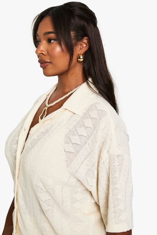 Textured fabric with distinctive geometric pattern throughout
        Relaxed fit with short sleeves for effortless beach style
        Classic collar design with full button-through front
        Versatile shirt silhouette that pairs perfectly with matching trousers
        Plus size design crafted specifically for curvy figures
    
    This structured Mix & Match shirt from Boohoo is your essential beach holiday companion. The textured fabric creates visual interest while the relaxed silhouette ensures comfort during warm-weather escapes. Style as seen with the coordinating wide-leg trousers for a sophisticated beach-to-bar ensemble, or wear unbuttoned over your favourite swimwear as a chic cover-up. The neutral tone makes it incredibly versatile for holiday packing, while the short sleeves offer just the right amount of coverage for sunny afternoons. Perfect for lounging by the pool with a cocktail, strolling along the promenade, or enjoying sunset dinners at beachfront restaurants. Accessorise with layered necklaces and statement bangles as shown for a complete resort-ready look that transitions seamlessly from daytime relaxation to evening socialising.