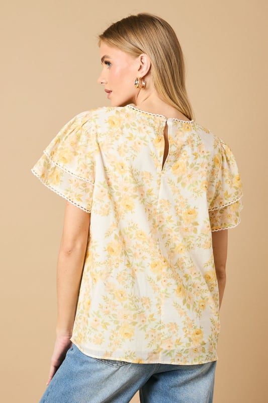 Charming crew neck blouse with delicate frill shoulder detail for a feminine touch
        Elegant pintuck detailing on the front bodice creates subtle texture and visual interest
        Dainty floral print throughout with a soft, romantic aesthetic
        Fluttery short sleeves with pretty trim detailing for added dimension
        Relaxed silhouette with a subtle empire waist for a flattering, comfortable fit
    
    This enchanting Oasis blouse combines classic femininity with contemporary styling. The delicate frill shoulders and pintuck detailing create a wonderfully romantic silhouette that's perfect for everyday wear. Style with relaxed denim jeans and flat sandals for casual weekend brunches, or pair with tailored trousers and ballet flats for a polished office look. The versatile design transitions beautifully from day to evening - simply swap your daytime accessories for statement earrings and a clutch bag for dinner with friends. The blouse's relaxed fit ensures all-day comfort whilst maintaining a put-together appearance, making it an ideal choice for family gatherings or casual meetups. This charming piece captures Oasis's signature feminine aesthetic whilst offering practical versatility for your everyday wardrobe.
