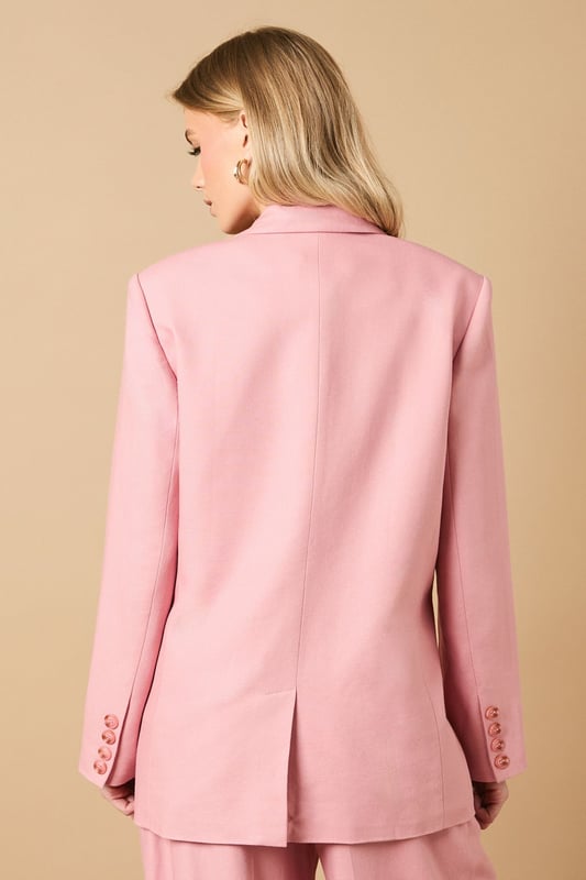 Oversized silhouette with relaxed shoulders for a contemporary, fashion-forward look
        Notched lapels and structured tailoring create a refined, elegant appearance
        Front button fastening with coordinating buttons for a cohesive finish
        Functional front pockets perfect for adding practicality to your formal ensemble
        Linen-look fabric offers a lightweight feel ideal for warmer weather occasions
    
    Make a statement with this beautifully crafted oversized blazer from Oasis. The relaxed fit creates a modern silhouette whilst maintaining a sophisticated edge that works brilliantly for both formal and casual settings. Style as seen with the matching wide-leg trousers for a coordinated suit that commands attention at summer weddings or garden parties. For everyday elegance, pair with slim-fit trousers and a simple camisole, finishing with delicate jewellery as shown on our model. The versatile nature of this blazer makes it perfect for layering during transitional seasons - wear open over a fitted dress for race day events or buttoned up with tailored shorts for a contemporary twist on occasion dressing. The clean lines and feminine cut embody Oasis' signature style whilst offering endless styling possibilities.