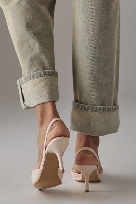 Elegant slingback design with secure ankle strap for comfortable all-day wear
        Pointed toe silhouette creates a flattering, leg-lengthening effect
        Sleek high stiletto heel measuring between 7-9cm adds sophisticated height
        Smooth faux leather finish offers a polished, versatile appearance
        Cushioned footbed provides essential comfort without compromising on style
    
    The Faith Dottie court shoes strike the perfect balance between contemporary design and timeless appeal. The pointed toe and slingback silhouette create a refined shape that complements both casual and smart-casual ensembles. Style these versatile heels with relaxed denim and a floaty blouse for family gatherings, or pair with tailored trousers for an elevated daytime look. The 7-9cm stiletto heel offers just the right amount of height whilst remaining appropriate for everyday occasions. The secure slingback strap ensures these courts stay comfortably in place throughout the day, making them ideal for shopping trips or casual lunches with friends. Their clean lines and sophisticated shape make them a wardrobe essential that will complement numerous outfits in your collection, offering endless styling possibilities for daywear occasions.