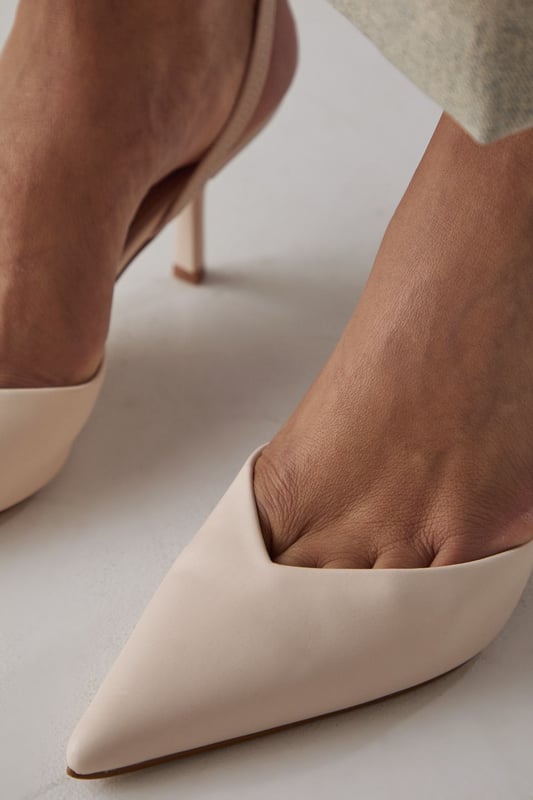 Elegant slingback design with secure ankle strap for comfortable all-day wear
        Pointed toe silhouette creates a flattering, leg-lengthening effect
        Sleek high stiletto heel measuring between 7-9cm adds sophisticated height
        Smooth faux leather finish offers a polished, versatile appearance
        Cushioned footbed provides essential comfort without compromising on style
    
    The Faith Dottie court shoes strike the perfect balance between contemporary design and timeless appeal. The pointed toe and slingback silhouette create a refined shape that complements both casual and smart-casual ensembles. Style these versatile heels with relaxed denim and a floaty blouse for family gatherings, or pair with tailored trousers for an elevated daytime look. The 7-9cm stiletto heel offers just the right amount of height whilst remaining appropriate for everyday occasions. The secure slingback strap ensures these courts stay comfortably in place throughout the day, making them ideal for shopping trips or casual lunches with friends. Their clean lines and sophisticated shape make them a wardrobe essential that will complement numerous outfits in your collection, offering endless styling possibilities for daywear occasions.
