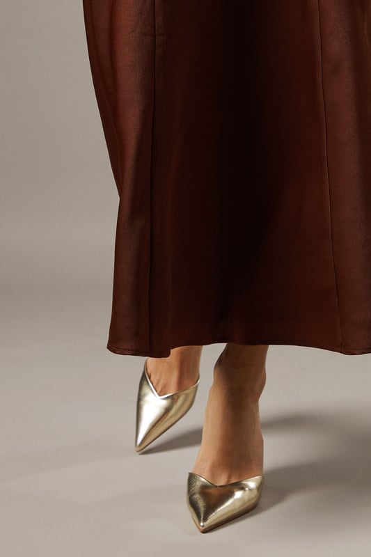 Elegant slingback design with secure ankle strap for comfortable all-day wear
        Pointed toe silhouette creates a flattering, leg-lengthening effect
        Sleek high stiletto heel measuring between 7-9cm adds sophisticated height
        Smooth faux leather finish offers a polished, versatile appearance
        Cushioned footbed provides essential comfort without compromising on style
    
    The Faith Dottie court shoes strike the perfect balance between contemporary design and timeless appeal. The pointed toe and slingback silhouette create a refined shape that complements both casual and smart-casual ensembles. Style these versatile heels with relaxed denim and a floaty blouse for family gatherings, or pair with tailored trousers for an elevated daytime look. The 7-9cm stiletto heel offers just the right amount of height whilst remaining appropriate for everyday occasions. The secure slingback strap ensures these courts stay comfortably in place throughout the day, making them ideal for shopping trips or casual lunches with friends. Their clean lines and sophisticated shape make them a wardrobe essential that will complement numerous outfits in your collection, offering endless styling possibilities for daywear occasions.