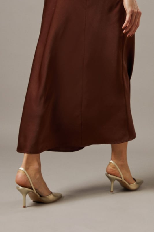 Elegant slingback design with secure ankle strap for comfortable all-day wear
        Pointed toe silhouette creates a flattering, leg-lengthening effect
        Sleek high stiletto heel measuring between 7-9cm adds sophisticated height
        Smooth faux leather finish offers a polished, versatile appearance
        Cushioned footbed provides essential comfort without compromising on style
    
    The Faith Dottie court shoes strike the perfect balance between contemporary design and timeless appeal. The pointed toe and slingback silhouette create a refined shape that complements both casual and smart-casual ensembles. Style these versatile heels with relaxed denim and a floaty blouse for family gatherings, or pair with tailored trousers for an elevated daytime look. The 7-9cm stiletto heel offers just the right amount of height whilst remaining appropriate for everyday occasions. The secure slingback strap ensures these courts stay comfortably in place throughout the day, making them ideal for shopping trips or casual lunches with friends. Their clean lines and sophisticated shape make them a wardrobe essential that will complement numerous outfits in your collection, offering endless styling possibilities for daywear occasions.