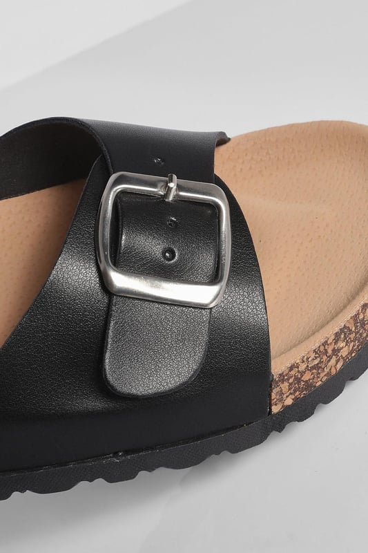 Stylish buckle footbed slider with adjustable strap
        Comfortable cork-effect footbed for enhanced support
        Flat heel between 0 and 2cm for easy all-day wear
        Versatile design suitable for various casual occasions
        Durable synthetic materials for long-lasting use
    
    Step into comfort and style with these trendy buckle footbed sliders from Boohoo. Perfect for the fashion-forward woman who values both aesthetics and practicality, these sandals are a must-have for your casual wardrobe. The adjustable strap ensures a customised fit, while the cork-effect footbed provides a natural, earthy look and superior comfort. Pair them with cropped jeans and a breezy top for a laid-back weekend brunch, or slip them on with a floaty sundress for a relaxed day at the beach. Their versatility makes them ideal for family gatherings, casual outings, or simply lounging at home. The flat heel offers stability and comfort for extended wear, making these sliders your go-to choice for effortless summer style that doesn't compromise on comfort.