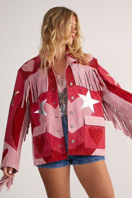 Genuine suede jacket featuring dramatic fringe detailing across the shoulders and sleeves
        Statement star pattern design for a bold, eye-catching look
        Button-through front closure with classic collar
        Practical patch pockets at the front
        Relaxed silhouette for comfortable layering
    
    Make a striking entrance in this show-stopping Real Suede Heart Fringe Jacket from Nasty Gal. The dramatic fringe detailing creates movement with every step, whilst the bold star pattern commands attention wherever you go. Perfect for those nights when ordinary simply won't do, this jacket pairs brilliantly with denim shorts and metallic boots as shown, or style with skinny jeans and a simple camisole to let the jacket take centre stage. The genuine suede construction offers a luxurious feel that will develop character over time. Whether you're heading to a gig, meeting friends at a trendy bar, or dancing the night away, this distinctive piece will ensure you stand out from the crowd. The relaxed fit allows for easy layering over both casual and dressier ensembles, making it a versatile addition to your going-out wardrobe.