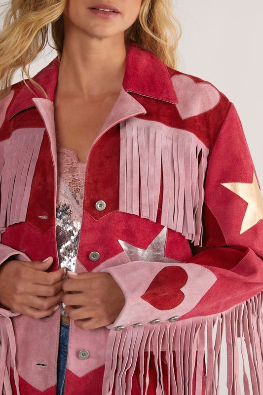 Genuine suede jacket featuring dramatic fringe detailing across the shoulders and sleeves
        Statement star pattern design for a bold, eye-catching look
        Button-through front closure with classic collar
        Practical patch pockets at the front
        Relaxed silhouette for comfortable layering
    
    Make a striking entrance in this show-stopping Real Suede Heart Fringe Jacket from Nasty Gal. The dramatic fringe detailing creates movement with every step, whilst the bold star pattern commands attention wherever you go. Perfect for those nights when ordinary simply won't do, this jacket pairs brilliantly with denim shorts and metallic boots as shown, or style with skinny jeans and a simple camisole to let the jacket take centre stage. The genuine suede construction offers a luxurious feel that will develop character over time. Whether you're heading to a gig, meeting friends at a trendy bar, or dancing the night away, this distinctive piece will ensure you stand out from the crowd. The relaxed fit allows for easy layering over both casual and dressier ensembles, making it a versatile addition to your going-out wardrobe.