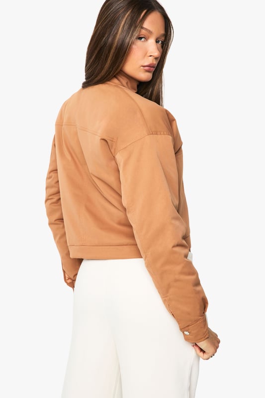 Distinctive funnel collar design for added warmth and contemporary style
        Cropped silhouette perfect for highlighting high-waisted bottoms
        Ribbed cuffs and hem for a snug, comfortable fit
        Front zip fastening for easy wear and versatile styling options
        Practical side pockets for everyday functionality
    
    This bomber jacket combines classic athletic appeal with modern design elements, making it a versatile addition to your casual wardrobe. The distinctive funnel collar adds a contemporary twist while providing extra protection against the elements. Style with wide-leg trousers and a crop top as shown for an effortlessly cool daytime look, or pair with slim-fit jeans and trainers for weekend coffee runs. The cropped length works brilliantly with high-waisted bottoms, creating a balanced silhouette. Perfect for family gatherings, casual brunches or shopping trips with friends, this Boohoo bomber can be layered over hoodies during cooler months or worn with lightweight tops when the temperature rises. Accessorise with a baseball cap and minimal jewellery for an understated finish that maintains the jacket's relaxed yet fashion-forward appeal.