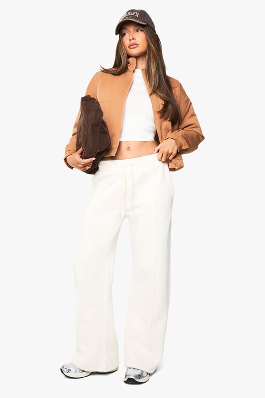 Distinctive funnel collar design for added warmth and contemporary style
        Cropped silhouette perfect for highlighting high-waisted bottoms
        Ribbed cuffs and hem for a snug, comfortable fit
        Front zip fastening for easy wear and versatile styling options
        Practical side pockets for everyday functionality
    
    This bomber jacket combines classic athletic appeal with modern design elements, making it a versatile addition to your casual wardrobe. The distinctive funnel collar adds a contemporary twist while providing extra protection against the elements. Style with wide-leg trousers and a crop top as shown for an effortlessly cool daytime look, or pair with slim-fit jeans and trainers for weekend coffee runs. The cropped length works brilliantly with high-waisted bottoms, creating a balanced silhouette. Perfect for family gatherings, casual brunches or shopping trips with friends, this Boohoo bomber can be layered over hoodies during cooler months or worn with lightweight tops when the temperature rises. Accessorise with a baseball cap and minimal jewellery for an understated finish that maintains the jacket's relaxed yet fashion-forward appeal.