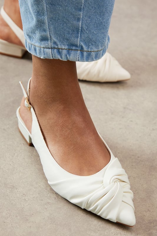 Elegant pointed toe design with sophisticated twist detail at the front
        Comfortable low heel measuring between 2.5-4.5cm for all-day wearability
        Adjustable slingback strap with buckle fastening for a secure fit
        Faux leather finish offering a polished, sophisticated appearance
        Versatile silhouette that pairs beautifully with both trousers and dresses
    
    These sophisticated slingbacks strike the perfect balance between style and comfort. The elegant pointed toe and distinctive twist detail create a refined silhouette, whilst the practical low heel ensures you can wear them from morning to evening without discomfort. Style them with rolled-up jeans for a casual daytime look that still conveys sophistication, or pair with tailored trousers and a crisp white shirt for family gatherings or lunch dates. The adjustable slingback design offers both security and a touch of feminine charm, making these shoes a versatile addition to your wardrobe. Their timeless appeal works wonderfully for various daywear occasions, from shopping trips to casual office environments. The sleek design ensures they'll complement virtually any outfit, making them a reliable go-to when you want to look effortlessly put-together without sacrificing comfort.