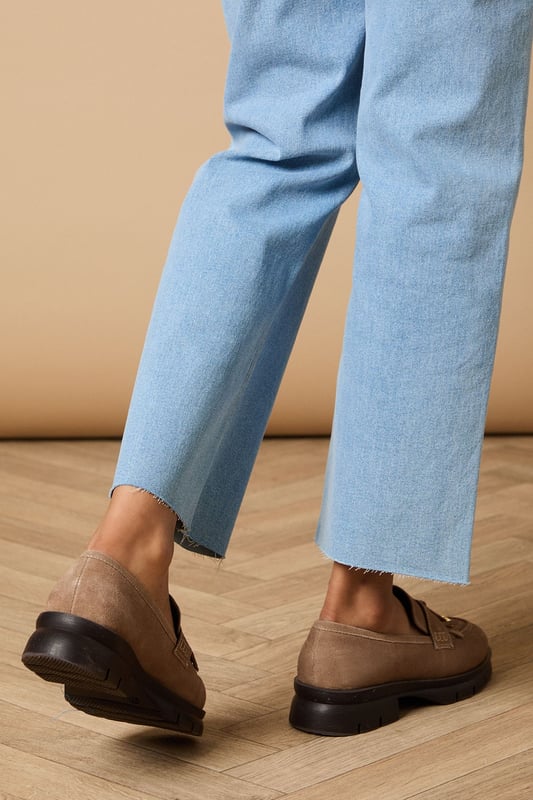 Crafted from soft suede with decorative tassel detailing for a classic finish
        Chunky sole provides excellent grip and all-day comfort
        Flat heel height (under 2cm) ideal for extended wear
        Traditional loafer silhouette with contemporary proportions
        Gold-tone hardware accent adds a subtle touch of sophistication
    
    The Brooke Suede Tassel Loafers from Oasis present the perfect blend of comfort and style for your everyday wardrobe. These versatile flats showcase charming tassel detailing that nods to traditional loafer design whilst maintaining a fresh, feminine appeal. Style them as seen with relaxed denim and a flowing blouse for casual weekend brunches, or pair with tailored trousers and a crisp shirt for a smart-casual office look. The chunky, durable sole offers practical wearability whilst the neutral tone ensures these loafers will complement virtually any outfit in your collection. Perfect for city exploring, shopping trips or casual gatherings where comfort cannot be compromised, these loafers will quickly become your go-to footwear choice for occasions that require both style and practicality.