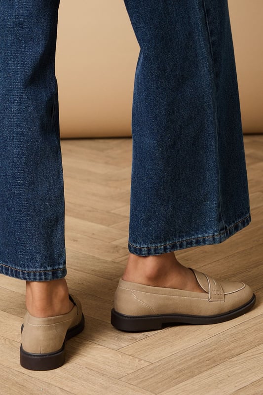 Classic penny loafer design with a contemporary faux suede finish
        Comfortable flat heel measuring between 0-2cm for all-day wearability
        Contrast stitching detail adds subtle visual interest
        Durable synthetic outsole provides reliable grip and longevity
        Versatile slip-on style with traditional penny slot detailing
    
    These Beech Faux Suede Penny Loafers from Oasis offer the perfect blend of timeless style and modern comfort. Pair them with wide-leg denim and an oversized white shirt for an effortlessly chic daytime look, or style with tailored trousers and a blouse for more polished occasions. The neutral tone makes these loafers incredibly versatile, working beautifully with floral dresses and skirts for a feminine touch that's quintessentially Oasis. Their flat design ensures comfort during family gatherings or weekend brunches, whilst the classic penny loafer silhouette adds a sophisticated element to casual ensembles. These shoes transition seamlessly from office to weekend, making them a wardrobe essential that will complement your existing collection whilst adding a refined finishing touch to any outfit.