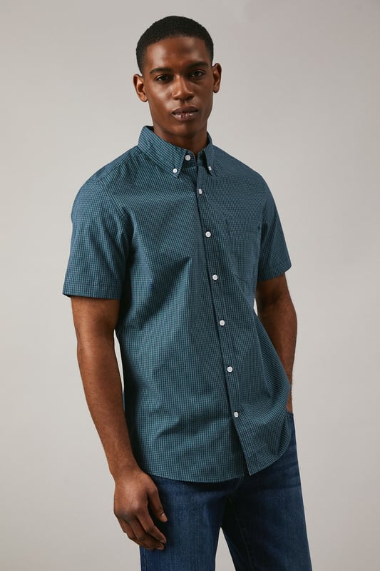 Classic button-down collar with traditional gingham check pattern
        Short sleeves with neat hem for warm-weather comfort
        Chest pocket detail adds functional style
        Back yoke with centre pleat for enhanced movement
        Regular fit silhouette suitable for various body types
    
    This Maine gingham check shirt combines timeless British style with everyday versatility. The woven fabric offers a structured yet comfortable feel, perfect for casual occasions that call for a touch of refinement. Style it as shown with dark denim jeans and white trainers for a relaxed weekend look, or pair with chino shorts and loafers for summer garden parties. The button-down collar maintains a neat appearance throughout the day, while the short sleeves make it ideal for family gatherings and casual outings during warmer months. This shirt transitions effortlessly from daytime casual to evening drinks, making it a wardrobe essential that works across multiple seasons. Layer under a lightweight jumper when temperatures drop or wear open over a plain t-shirt for a more contemporary approach to casual dressing.