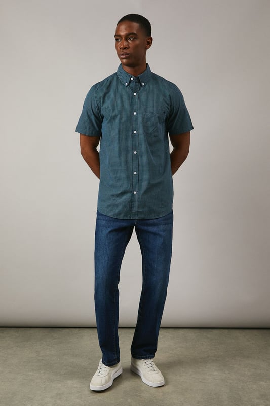 Classic button-down collar with traditional gingham check pattern
        Short sleeves with neat hem for warm-weather comfort
        Chest pocket detail adds functional style
        Back yoke with centre pleat for enhanced movement
        Regular fit silhouette suitable for various body types
    
    This Maine gingham check shirt combines timeless British style with everyday versatility. The woven fabric offers a structured yet comfortable feel, perfect for casual occasions that call for a touch of refinement. Style it as shown with dark denim jeans and white trainers for a relaxed weekend look, or pair with chino shorts and loafers for summer garden parties. The button-down collar maintains a neat appearance throughout the day, while the short sleeves make it ideal for family gatherings and casual outings during warmer months. This shirt transitions effortlessly from daytime casual to evening drinks, making it a wardrobe essential that works across multiple seasons. Layer under a lightweight jumper when temperatures drop or wear open over a plain t-shirt for a more contemporary approach to casual dressing.