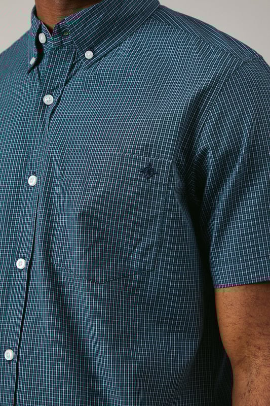 Classic button-down collar with traditional gingham check pattern
        Short sleeves with neat hem for warm-weather comfort
        Chest pocket detail adds functional style
        Back yoke with centre pleat for enhanced movement
        Regular fit silhouette suitable for various body types
    
    This Maine gingham check shirt combines timeless British style with everyday versatility. The woven fabric offers a structured yet comfortable feel, perfect for casual occasions that call for a touch of refinement. Style it as shown with dark denim jeans and white trainers for a relaxed weekend look, or pair with chino shorts and loafers for summer garden parties. The button-down collar maintains a neat appearance throughout the day, while the short sleeves make it ideal for family gatherings and casual outings during warmer months. This shirt transitions effortlessly from daytime casual to evening drinks, making it a wardrobe essential that works across multiple seasons. Layer under a lightweight jumper when temperatures drop or wear open over a plain t-shirt for a more contemporary approach to casual dressing.