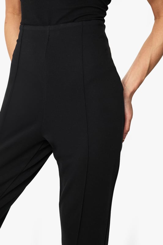 Sleek slim-fit design crafted from ponte fabric for exceptional shape retention
        Streamlined silhouette with clean front seam detailing for a polished look
        Comfortable stretch blend that moves with your body throughout the day
        Versatile mid-rise waistband offering flattering support
        Classic straight-leg cut that pairs effortlessly with both casual and smart attire
    
    These Boohoo slim-fit trousers are the wardrobe essential you've been searching for. The ponte fabric creates a smooth, structured silhouette while maintaining remarkable comfort for all-day wear. Style them as shown with a simple black top and strappy heels for evening drinks, or dress them down with trainers and an oversized blazer for daytime chic. The versatile design transitions seamlessly from office to weekend brunch, making them ideal for the fashion-forward woman who values both style and practicality. For casual gatherings, pair with a relaxed tee and denim jacket, or elevate your look with a silky blouse and statement jewellery for family celebrations. These trousers offer the perfect balance of comfort and sophistication, ensuring they'll quickly become your go-to piece for countless occasions.