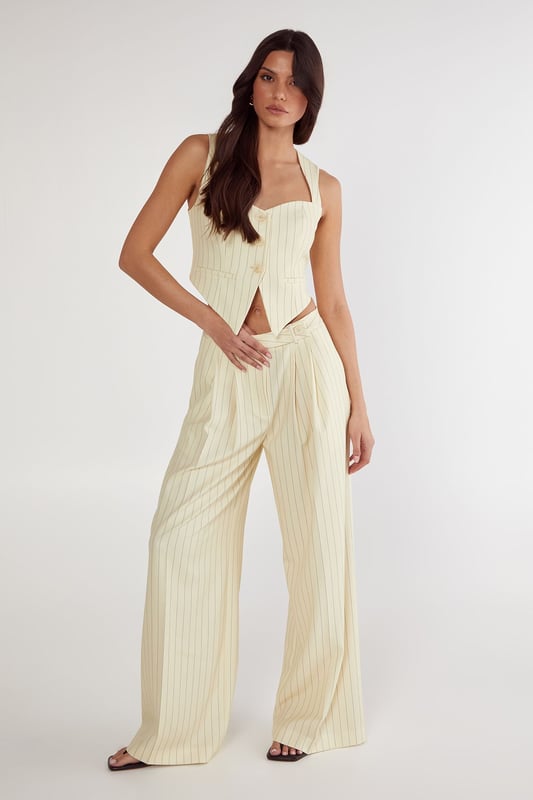Tailored wide-leg trousers with classic pinstripe pattern
        High-waisted design for a flattering silhouette
        Practical side pockets for everyday essentials
        Wide-leg cut offering comfortable movement
        Versatile design suitable for both professional and casual settings
    
    These Nasty Gal Butter Pinstripe Tailored Trousers bring sophisticated workwear to new heights. The high-waisted design creates a lengthening effect whilst the wide-leg silhouette offers both comfort and contemporary style. Pair with the matching crop top as shown for a coordinated two-piece ensemble that commands attention in the office, or style with a crisp white shirt and blazer for more formal workplace settings. For after-hours events, swap office footwear for strappy heels and add statement jewellery. The versatile pinstripe pattern honours traditional tailoring whilst the modern cut ensures these trousers transition seamlessly from boardroom presentations to evening drinks. The side pockets add practicality to this stylish piece, making these trousers an essential addition to your professional wardrobe.